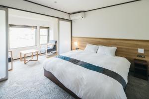 a bedroom with a large bed and a desk at RESI STAY Gion in Kyoto