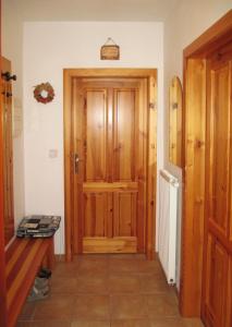 a hallway with a wooden door in a house at Apartman 300 in Janske Lazne