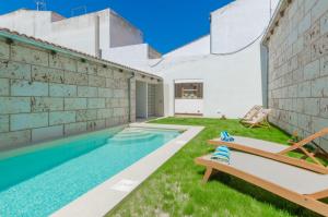 a swimming pool in the backyard of a house at Can Toni in Sa Pobla