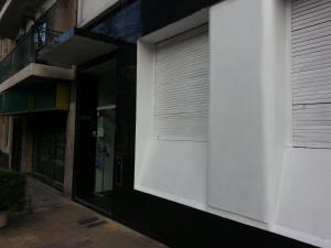 a white building with a roll up garage door at Hotel Isis in Buenos Aires