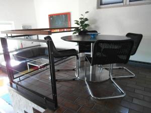 a table and chairs in a room with a table at Ferienhaus 956 in Biersdorf am See