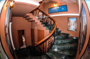 a spiral staircase in a house with a mirror at Apart voyage in Batumi
