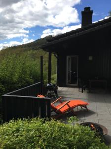 a patio with orange chairs and a house at Ferienhaus 956 in Biersdorf am See