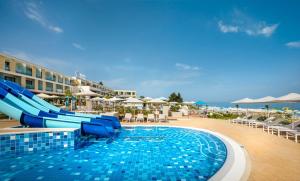 a swimming pool with a slide in a resort at Marea Suites, Valamar Collection in Poreč