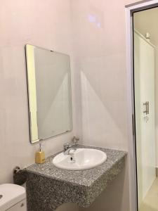 a bathroom with a sink and a mirror at Homestay BONO Mũi Né in Phan Thiet