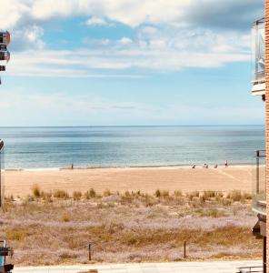 a view of a beach with people on it at Lets Holidays New Flat Beachfront In Castelldefels in Castelldefels