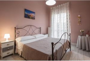 a bedroom with a bed and a table and a window at B&B President in Sant'Egidio del Monte Albino
