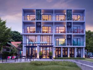 an exterior view of a building with large windows at Lub d Koh Samui Chaweng Beach in Chaweng