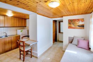 a kitchen with a table and a couch at PanDora Apartments in Moúdhros +49 photos