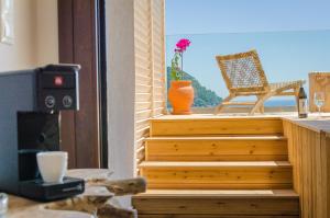 a set of stairs with a chair on a balcony at Agorastos Hotel in Koinyra