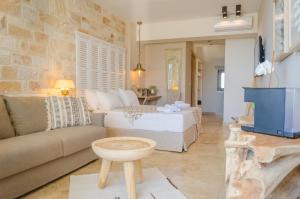 a living room with a bed and a couch at Agorastos Hotel in Koinyra