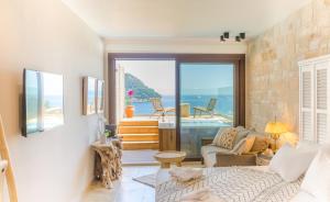 a living room with a view of the ocean at Agorastos Hotel in Koinyra