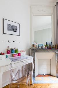 a white desk with a chair in a room at Veeve - Eiffel Elegance in Paris