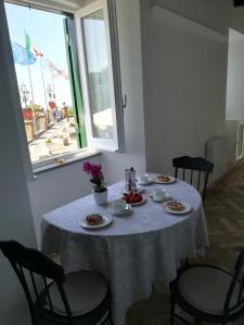 una mesa con un mantel blanco. en Holiday Homes - mini spa - Nemi (Roma), en Nemi