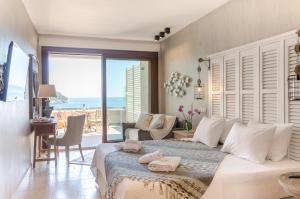 a bedroom with a bed with a view of the ocean at Agorastos Hotel in Koinyra
