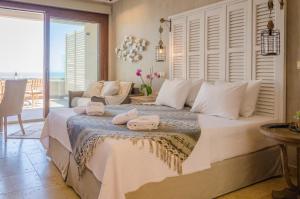 a bedroom with a bed with towels on it at Agorastos Hotel in Koinyra