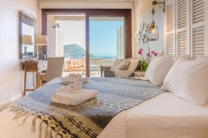 a bedroom with a large bed with towels on it at Agorastos Hotel in Koinyra