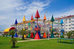 a colorful roller coaster in a park with a building at Barkhatnye Sezony Yekaterininsky Kvartal Resort in Adler