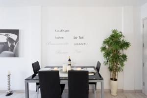 a dining room with a table and chairs and a plant at Fairytale in Adeje in Adeje +10 photos
