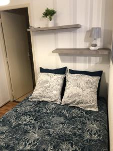 een bed met twee kussens erop bij Very quiet 2-room apartment - Old Port, Town center in La Rochelle