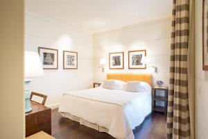 a bedroom with a bed with white sheets and pillows at Gallery Hotel Art - Lungarno Collection in Florence