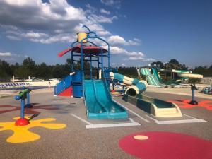 a playground with a slide in a park at MH 3CH à l'océan Landais chez Claiclé in Saint-Julien-en-Born