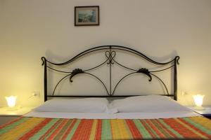 a bedroom with a large bed with two lamps at La casa di Matilde IUN P2341 in Cala Gonone