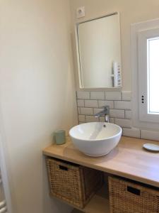 a bathroom with a white sink and a mirror at Chez Georges - Maison 2 - Les Gîtes du Verdon in Esparron-de-Verdon