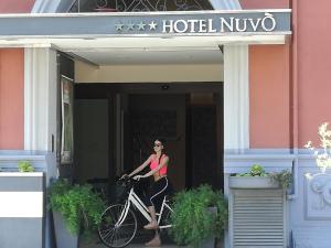 a woman riding a bike outside of a hotel nuevo at Hotel Nuvò in Naples