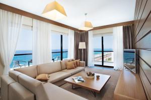 a living room with a couch and a table at Arfa Park-Hotel in Adler