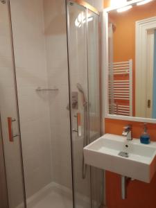 a bathroom with a shower and a sink at Prague Saints Apartments in Prague