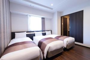 Postel nebo postele na pokoji v ubytování Nipponbashi Luxe Hotel
