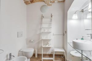 een witte badkamer met een wastafel en een toilet bij CasaMia in Alliste