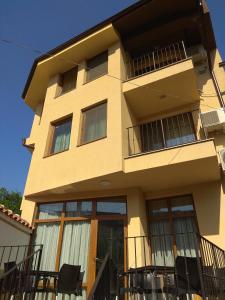 a building with balconies and chairs in front of it at Roots Hotel Old Town in Plovdiv