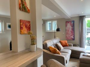 a living room with a couch and a table at The Barn House in Cranleigh