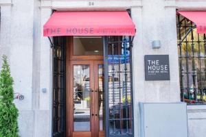 a building with a red awning over a door at The Editory House Ribeira Porto Hotel in Porto