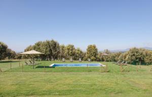a pool in a grassy field with trees and afficient at El Porxo de Mateus in Sagás