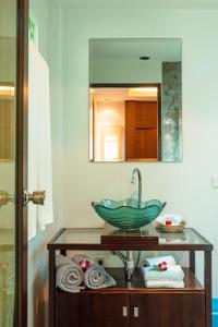 a bathroom with a sink and a mirror at Baan Armeen Cottage in Bang Tao Beach