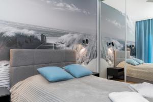 Łóżko lub łóżka w pokoju w obiekcie Apartamenty Gardenia Seaside by Noclegi Renters