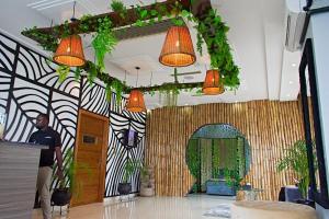 a man standing in a lobby with orange lights at Lagos Oriental Hotel in Lagos