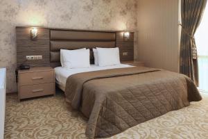 a hotel room with a large bed and a window at Balturk House Hotel in Kocaeli