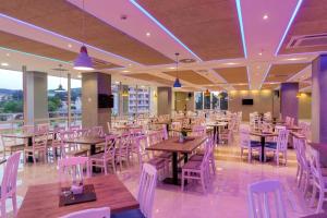 a restaurant with wooden tables and white chairs at HOTEL FRANCA ULCINJ in Ulcinj