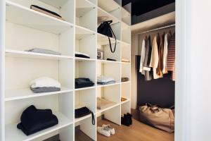 a walk in closet with white shelves at harry's home hotel & apartments in Vienna