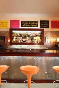 a bar with orange stools in a restaurant at Le Windsor, Jungle Art Hotel in Nice