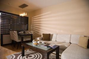 a living room with a couch and a table at Surmeli Istanbul Hotel in Istanbul