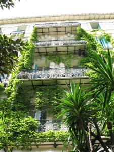 an apartment building with plants on the side of it at Le Windsor, Jungle Art Hotel in Nice