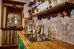 a kitchen with a sink and a wooden counter top at La casa del Balivo in Dorgali