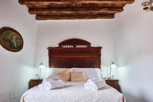 Łóżko lub łóżka w pokoju w obiekcie La casa del Balivo