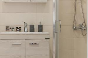 a bathroom with a shower and a sink at Saint George unique studio in Nafplio