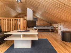 a living room with a white table and a couch at Holiday Home Tievatupa 1- isompi by Interhome in Ylläsjärvi